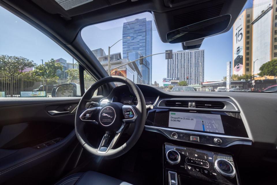 a waymo robotaxi jaguar i paces driverless car drives around downtown los angeles