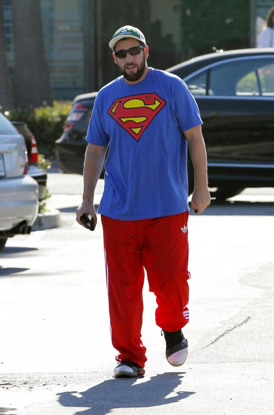 <p>It’s a bird, it’s a plane … it’s Adam Sandler in a Superman T-shirt – and track pants. (Photo by Bauer-Griffin/GC Images)</p>