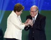 Brazilian President Dilma Rousseff (L) and FIFA President Sepp Blatter react on stage during the draw for the 2014 World Cup at the Costa do Sauipe resort in Sao Joao da Mata, Bahia state, December 6, 2013. REUTERS/Sergio Moraes