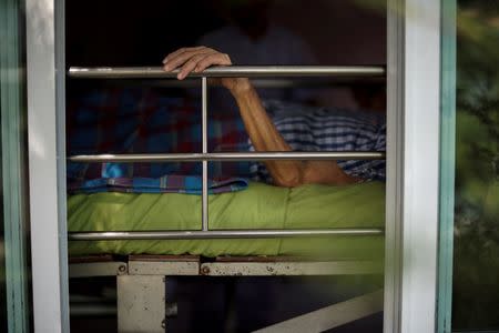 Uthai Sagulpongmalee, 70, lies in bed at Wellness Nursing Home Center in Ayutthaya, Thailand, April 9, 2016. REUTERS/Athit Perawongmetha
