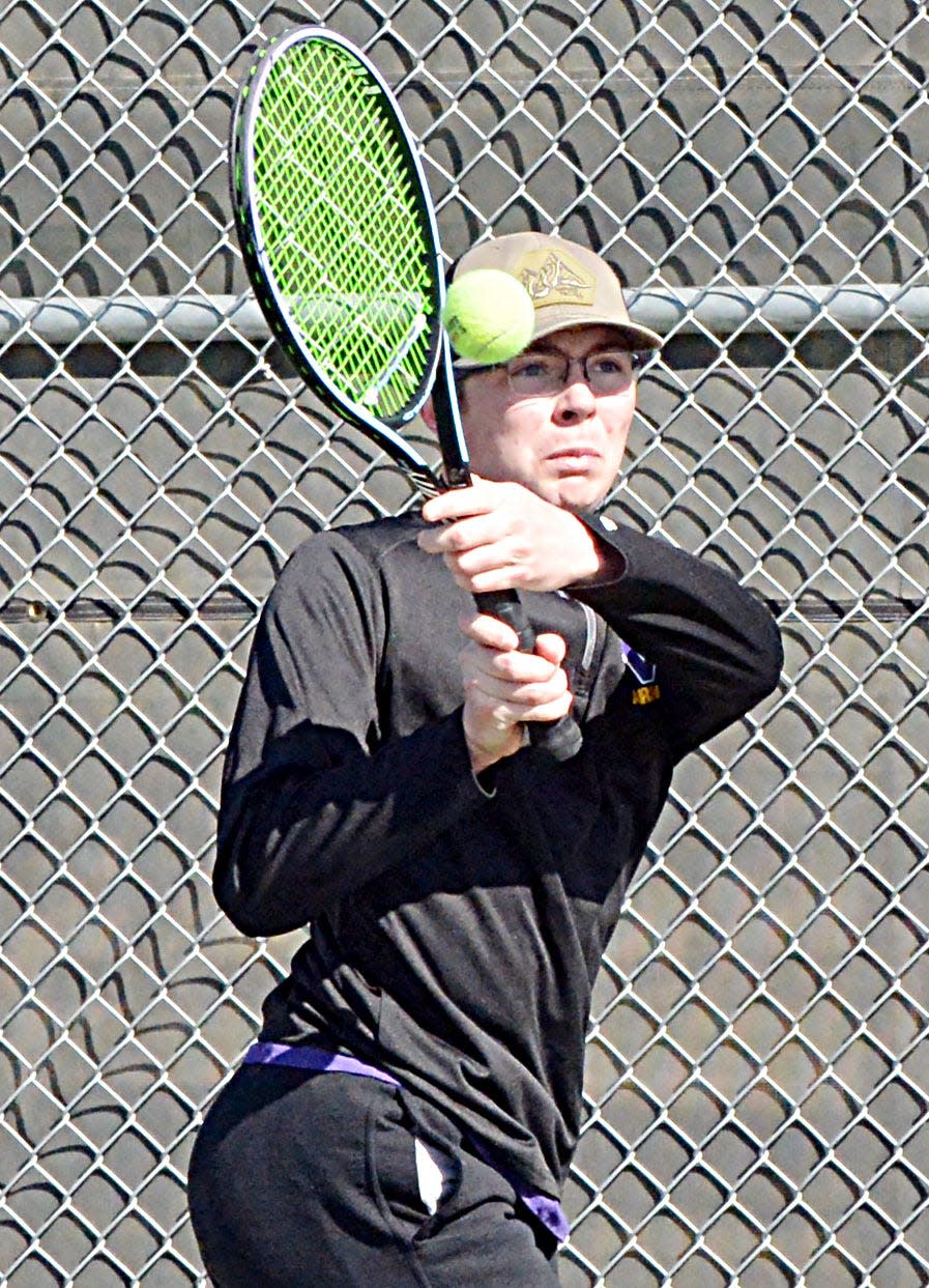 Watertown's Sam Karst hits a backhand return during a high school boys tennis triangular on Monday, April 17, 2023 at the Highland Park Tennis Courts in Watertown.
