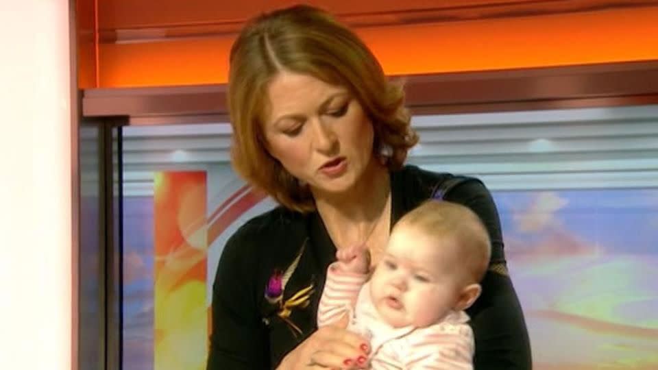 The moment the TV presenter picked up the baby. Source: BBC