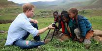 <p>Harry takes photos with local kids while on a trip to Mokhotlong, Lesotho. </p>