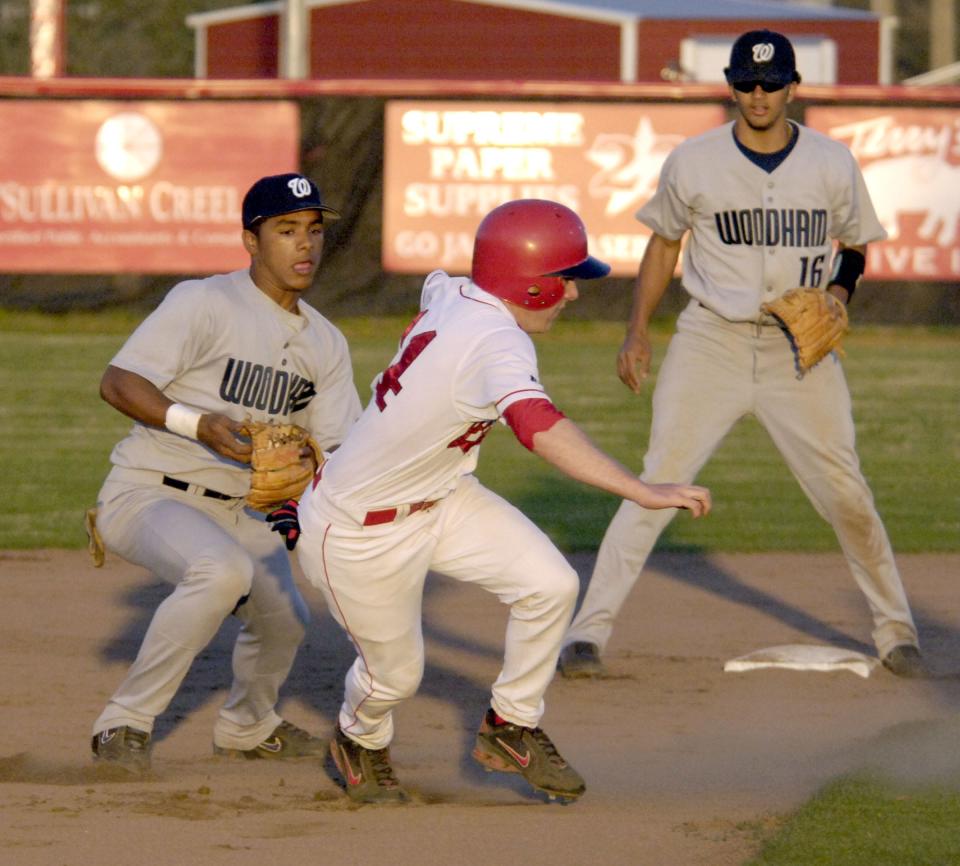 Woodham's C.J. Lindsey, left, moves in to attempt the tag on West Florida High's Daniel Wass, who was caught between Titan second baseman Kevin Jones, and third baseman Bubba Wells, for the rundown and was tagged out moments later as Woodham took on West Florida High at WFHS in 2007.