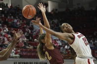 North Carolina State forward Kayla Jones (25) reaches for the ball with Elon guard Vanessa Taylor (22) during the second half of an NCAA college basketball game in Raleigh, N.C., Sunday, Dec. 5, 2021. (AP Photo/Gerry Broome)