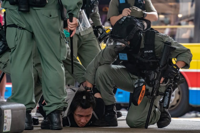 HONG KONG, CHINA - JULY 01: A man is being arrested by riot police during a demonstration against the new national security law on July 1, 2020 in Hong Kong, China. Hong Kong marks the 23rd anniversary of its handover to China on July 1 after Beijing imposed the new national security law. (Photo by Anthony Kwan/Getty Images)