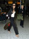 <p>Destiny's Child singer Michelle Williams arrives at London's Heathrow Airport, luggage in tow, in May 2004. </p>