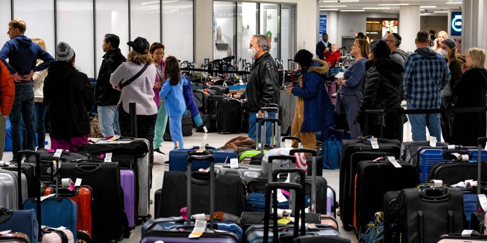 Passengers wait in line to claim their baggage at Nashville International Airport after their flights on Southwest Airlines were cancelled in Nashville, Tennessee, on December 27, 2022.