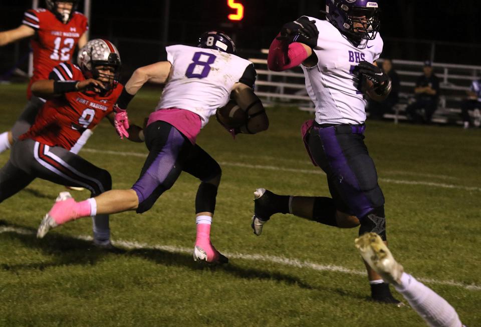 Burlington’s Caden Schisel (8) runs in for the touchdown as Nolan Simpson (7) clears the way with a block against a Fort Madison defender Friday in Fort Madison. Fort Madison’s Hayden Segoviano (9) is late on the tackle.