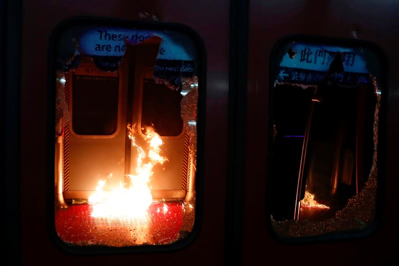 Fire burns after anti-government protesters threw Molotov cocktails at the MTR University station during a protest at the Chinese University of Hong Kong, Hong Kong