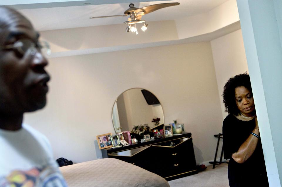 Michael, left, and Patricia Jackson stand in their bedroom after sifting through bank documents in their home Saturday, June 16, 2012, in Marietta, Ga. On a suburban cul-de-sac northwest of Atlanta, the Jacksons are struggling to keep a house worth $100,000 less than they owe. Their voices and those of many others tell the story of a country that, for all the economic turmoil of the past few years, continues to believe things will get better. But until it does, families are trying to hang on to what they've got left. The Great Recession claimed nearly 40 percent of Americans' wealth, the Federal Reserve reported last week. The new figures, showing Americans' net worth has plunged back to what it was in 1992, left economists shuddering. (AP Photo/David Goldman)