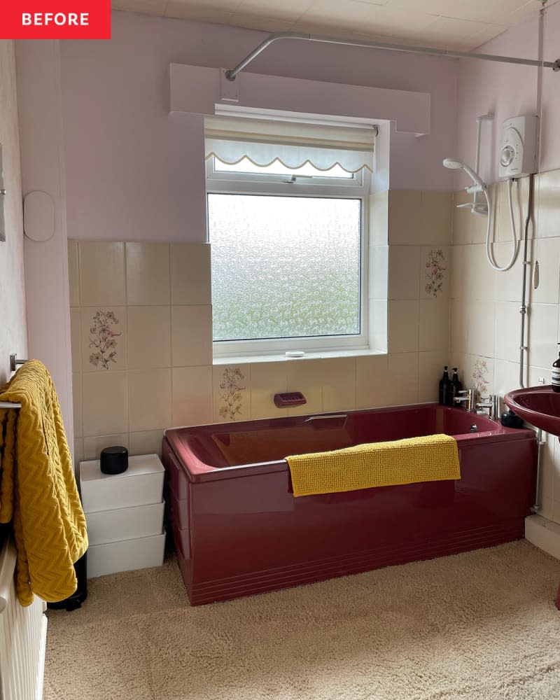 A burgundy tub with yellow towels matching the yellow towels on the near by rack.