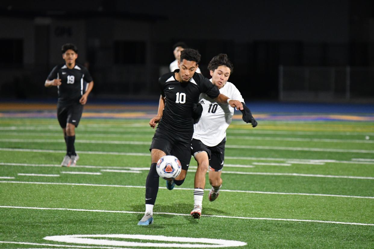 Channel Islands High's Alex Cuevas fends off a Pacifica High's Oscar Meza during the Raiders' 3-1 victory in a Pacific View League match on Thursday night.