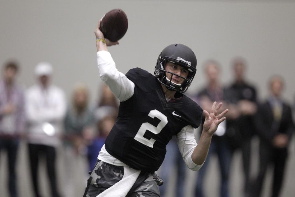 Texas A&M quarterback Johnny Manziel passes the ball during a drill at pro day for NFL football representatives in College Station, Texas, Thursday, March 27, 2014. (AP Photo/Patric Schneider)