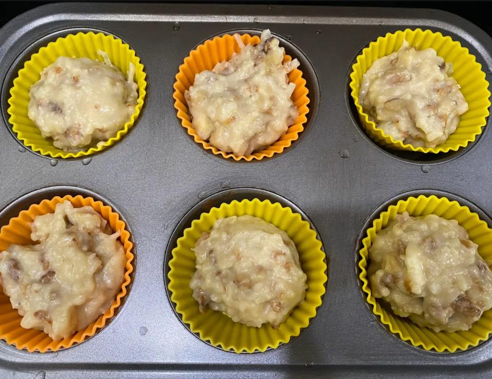 Banana-muffin batter in a muffin pan.