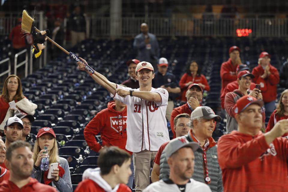 Washington Nationals fans celebrate after Game 4 of the baseball National League Championship Series against the St. Louis Cardinals Tuesday, Oct. 15, 2019, in Washington. The Nationals won 7-4 to win the series 4-0. (AP Photo/Jeff Roberson)