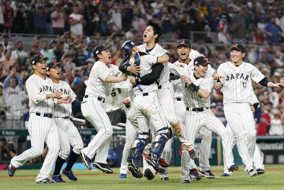 Japan player Shohei Ohtani (16) celebrates with his teammates after defeating the United States in World Baseball Classic championship game, Tuesday, March 21, 2023, in Miami. (AP Photo/Wilfredo Lee)