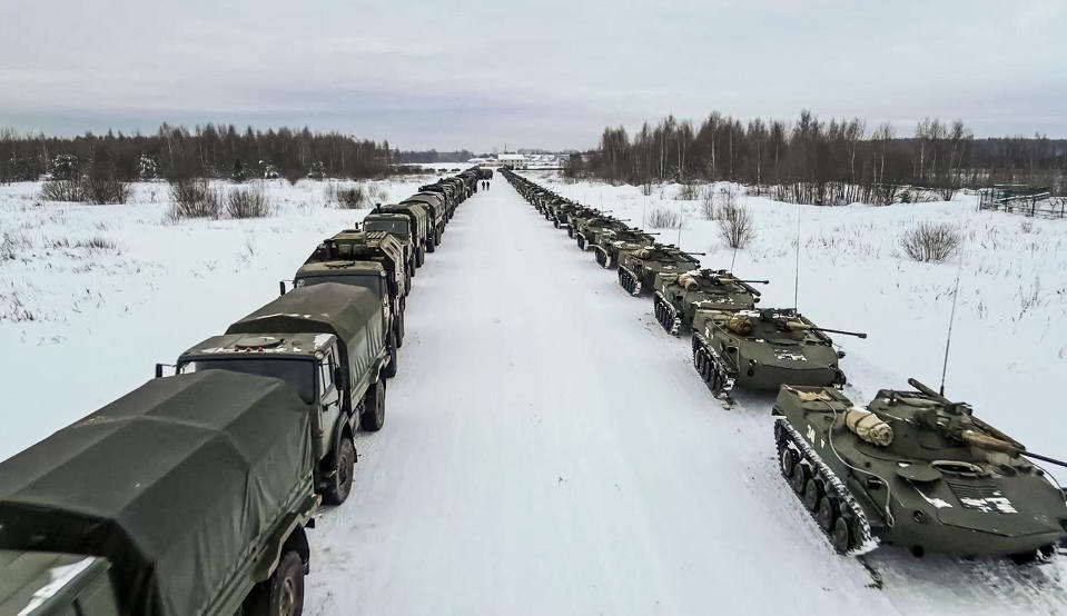 In this image taken from footage provided by the RU-RTR Russian television, Military vehicles of Russian peacekeepers parked waiting to be uploaded on Russian military planes at an airfield in Russia, Friday, Jan. 7, 2022. Over 70 cargo planes are being deployed in Russia's peacekeeping mission in Kazakhstan according to the Defense Ministry chief spokesman's briefing on Friday, after the worst street protests since the country gained independence three decades ago. The demonstrations began over a near-doubling of prices for a type of vehicle fuel and quickly spread across the country, reflecting wider discontent over the rule of the same party since independence. (RU-RTR Russian Television via AP)
