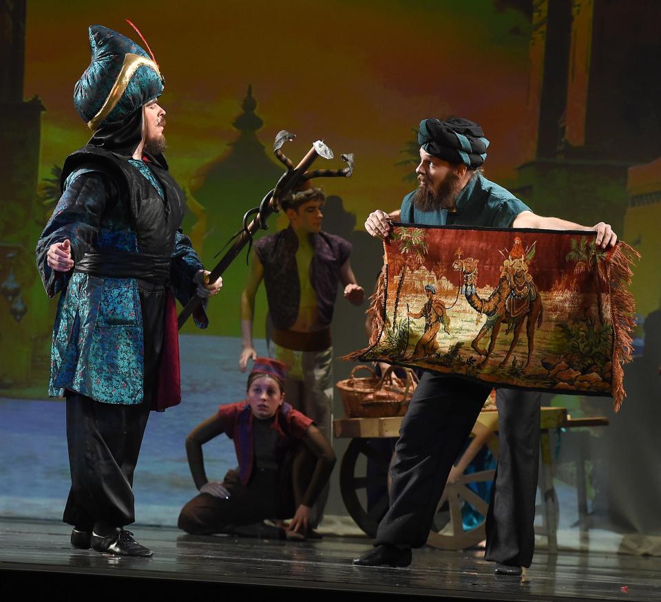 Joshua Mohler as the evil sorcerer Jafar looks at the carpet offered by Sultan, played by Matthew Pettrey, in the marketplace scene of Aladdin. This weekend's show at the River Raisin Centre of the Arts will be performed by 72 dancers from the River Raisin Ballet Company.