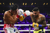 Abner Mares, right, fights Miguel Flores in a lightweights boxing match, Sunday, Sept. 4, 2022, in Los Angeles. (AP Photo/Ashley Landis)