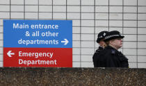 Police officers patrol outside a hospital where it is believed that Britain's Prime Minister Boris Johnson is undergoing tests after suffering from coronavirus symptoms, in London, Monday, April 6, 2020. British Prime Minister Boris Johnson has been admitted to a hospital with the coronavirus. Johnson's office says he is being admitted for tests because he still has symptoms 10 days after testing positive for the virus. (AP Photo/Frank Augstein)