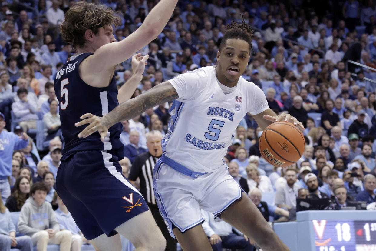 North Carolina forward Armando Bacot, right, drives against Virginia forward Ben Vander Plas, left, during the first half of an NCAA college basketball game, Saturday, Feb. 25, 2023, in Chapel Hill, N.C. (AP Photo/Chris Seward)