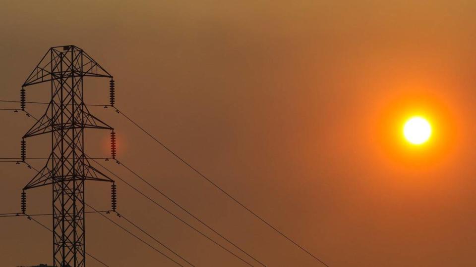 Air quality on the Central Coast is poor due to smoke from several fires burning in Monterey County. Sunrise in San Luis Obispo on Wednesday, Aug. 19, 2020, shows the sun behind PG&E high tension power lines.
