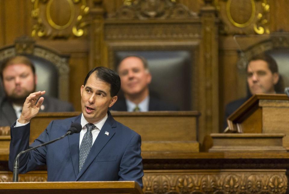 Wisconsin Gov. Scott Walker addresses a joint session of the Legislature in the Assembly chambers during the Governor's state of the state speech at the state Capitol on Tuesday, Jan. 10, 2017, in Madison, Wis. Behind Walker is Assembly Speaker Pro Tempore Tyler August, left, R-Lake Geneva, Assembly Speaker Robin Vos, R-Burlington, and Senate President Roger Roth, R-Appleton. (AP Photo/Andy Manis)