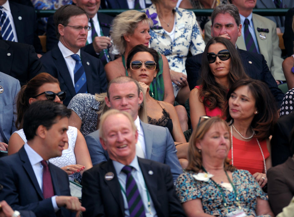 Royal box with Victoria Beckham and Tana Ramsey (centre), Wayne Rooney (second row) and Rod Laver and Ed Miliband (front row) on day thirteen of the Wimbledon Championships at The All England Lawn Tennis and Croquet Club, Wimbledon.