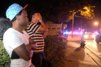 <p>Jermaine Towns, left, and Brandon Shuford wait down the street from a multiple shooting at a nightclub in Orlando, Fla., Sunday, June 12, 2016. Towns said his brother was in the club at the time. A gunman opened fire at a nightclub in central Florida, and multiple people have been wounded, police said Sunday. (AP Photo/Phelan M. Ebenhack) </p>