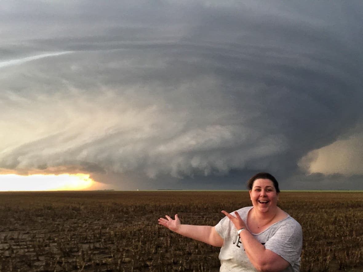 Storm chaser Beth Allan stands in front of a supercell.  (Submitted by Beth Allan - image credit)