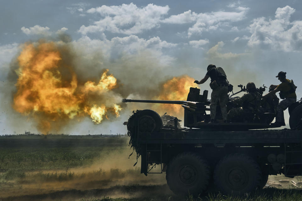 FILE - Ukrainian soldiers fire a cannon near the eastern city of Bakhmut in the Donetsk region of Ukraine, Monday, May 15, 2023. As the Kremlin watches for more signs of crumbling Western support for Ukraine, the Russian military has pressed attacks in several sectors in a bid to drain Kyiv's reserves and deplete its munitions. (AP Photo/Libkos, File)