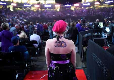 Kelly Kossett of Minnetonka MN looks for a seat before the tribute to late musician Prince, at the Xcel Energy Center in St. Paul, Minnesota, U.S. October 13, 2016. REUTERS/Craig Lassig