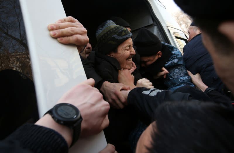 Kazakh law enforcement officers detain protesters during a rally held by opposition supporters in Almaty