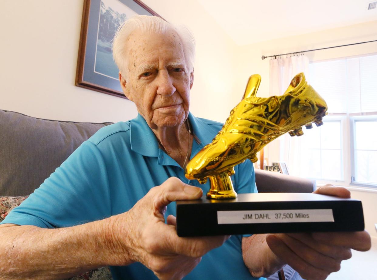 Jim Dahl, 95, shows the Golden Sneaker trophy he received from the staff at Brookdale Montrose after he reached 37,500 miles walking. Dahl, a former engineer at Goodyear, started tracking his distances in 1976 when he joined a health program at work.