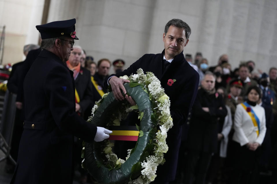 Belgium's Prime Minister Alexander De Croo, center, prepares to lay a wreath during an Armistice Day ceremony at the Menin Gate Memorial to the Missing in Ypres, Belgium, Thursday, Nov. 11, 2021. (AP Photo/Virginia Mayo)