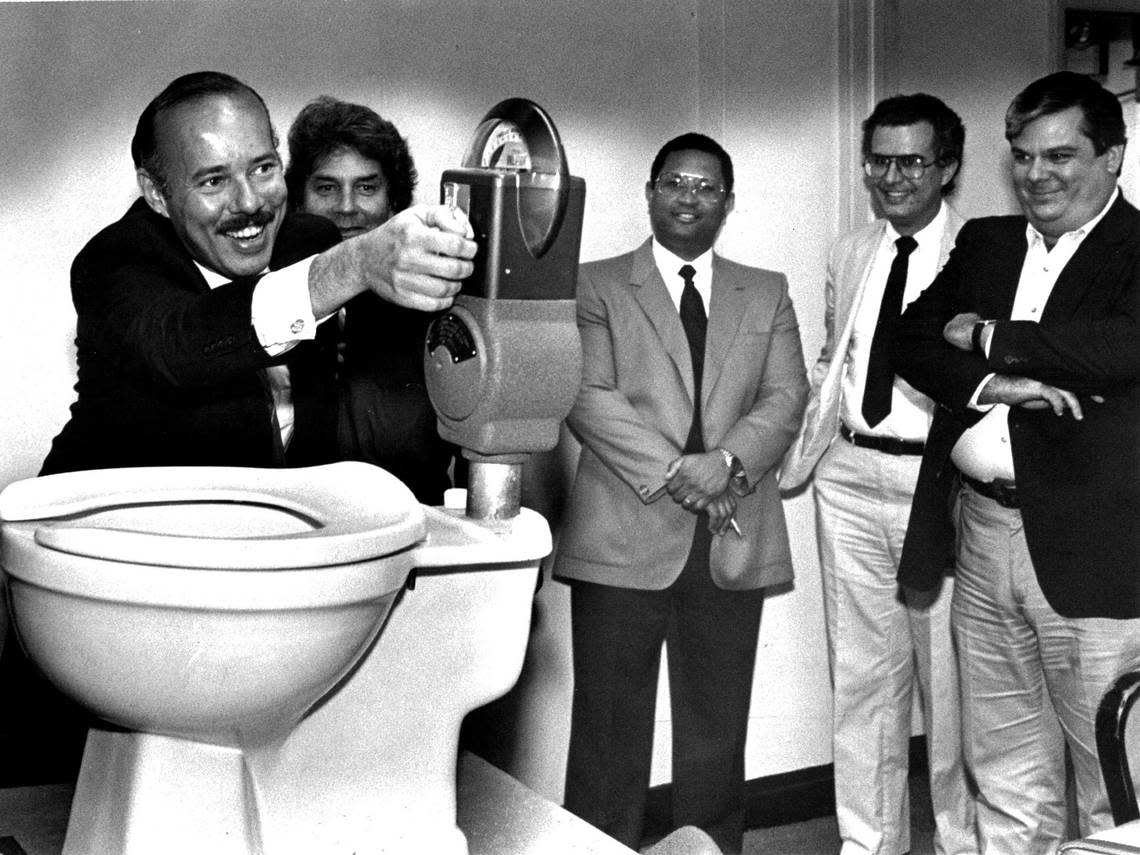 Demetrio Perez Jr. feeds the meter on a gift toilet given to him by Commissioner J.L. Plummer during his tenure on the Miami Commission in this May 24, 1985, photo.