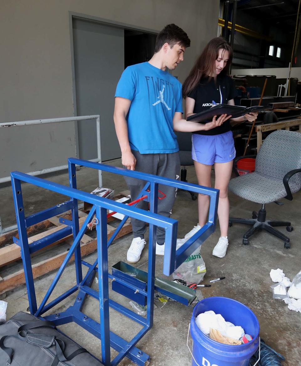 UA team members Josh Newell, left, and Riley Myers sign off on their packing list as they prepare for the competition in New Mexico.