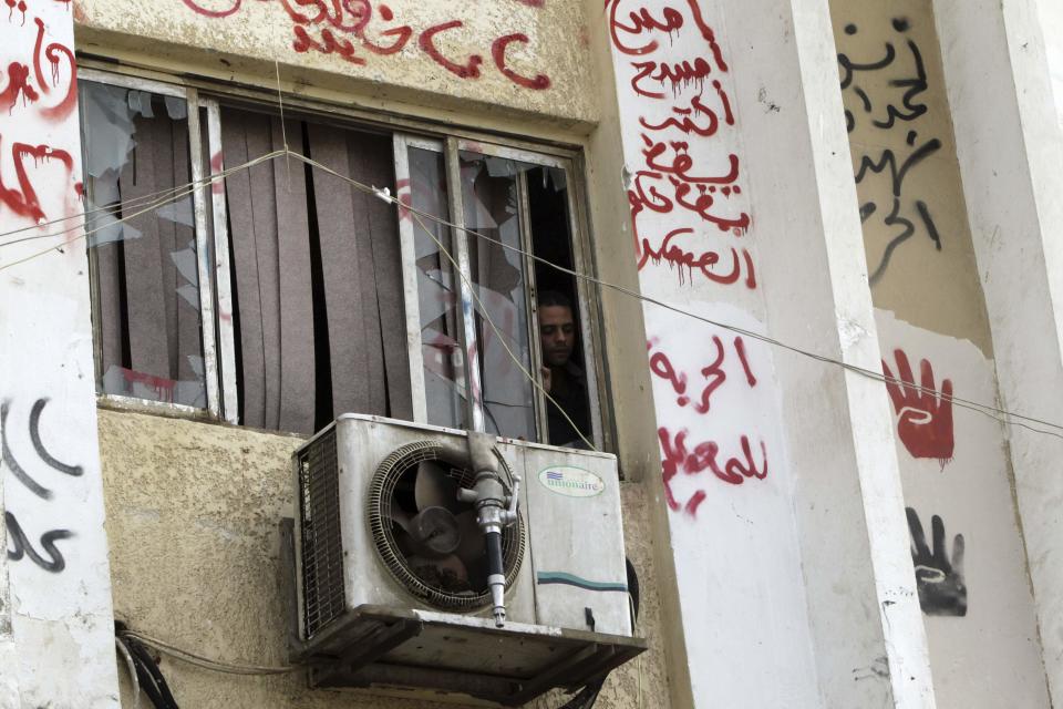 A man looks out behind broken window panes in al-Azhar university after student protests in Cairo October 30, 2013. Egyptian police fired teargas at protesting students at Cairo's al-Azhar university on Wednesday hours after authorities announced the detention of Muslim Brotherhood leader Essam El-Erian, part of a crackdown against the Islamist movement. (REUTERS/Mohamed Abd El Ghany)