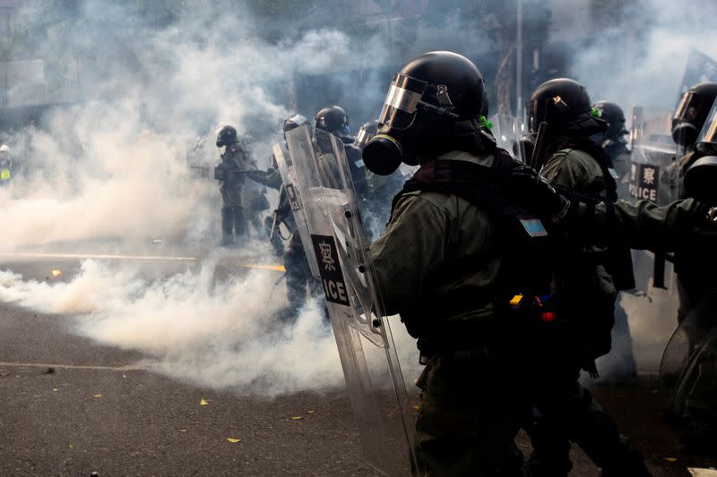 FILE PHOTO: Riot police officers are seen amid tear gas during a demonstration in Admiralty district Hong Kong