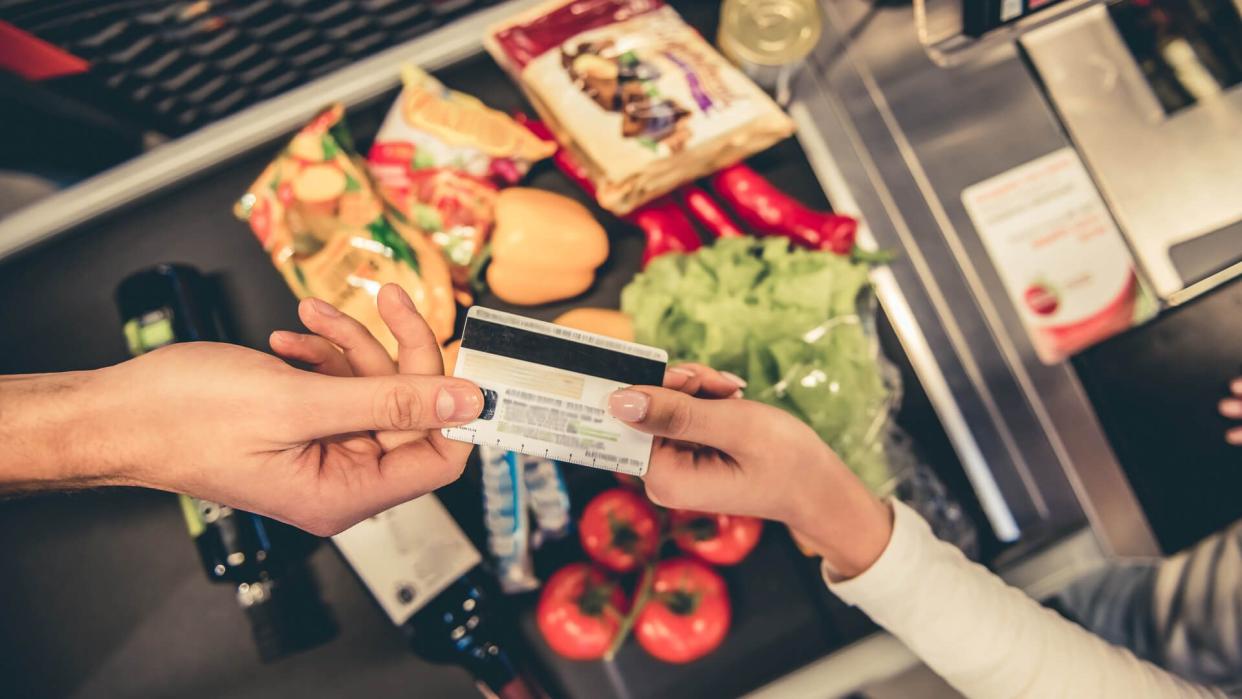 guy paying for groceries with credit card