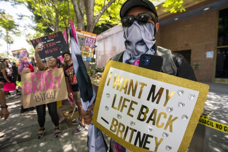 Carlos Moles, 26, stood outside a Los Angeles courthouse today with a crowd of about 150 people supporting Britney Spears.