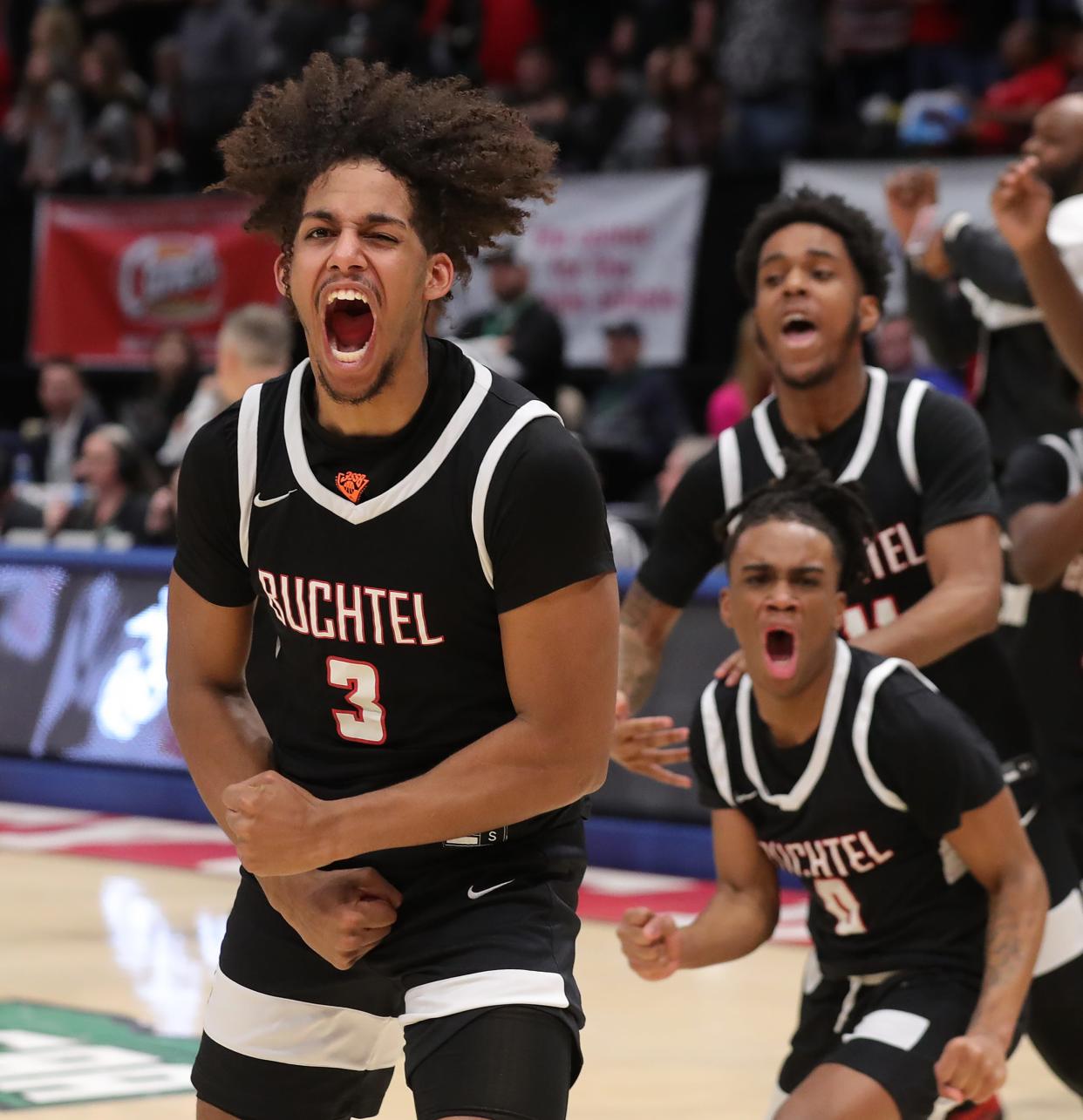 Buchtel guard Amire Robinson, left, gets fired up after the Griffins won the OHSAA Division II state championship basketball game, Sunday, March 19, 2023, in Dayton.