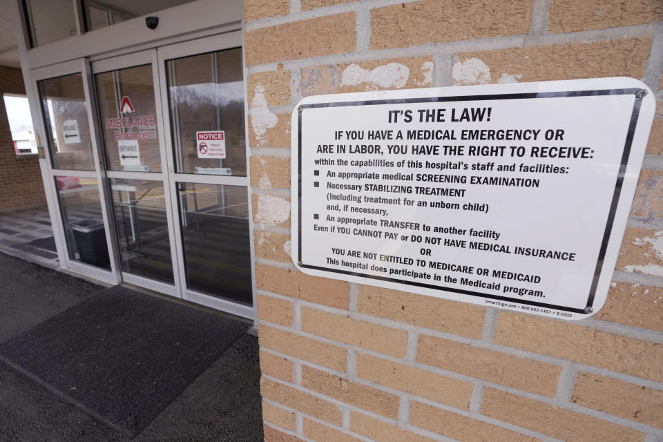 A sign spells out the rights a medical emergency patient has at the emergency room entrance outside the Alliance Healthcare System hospital in Holly Springs, Miss., Feb. 29, 2024. (AP Photo/Rogelio V. Solis)