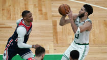 Boston Celtics forward Jayson Tatum (0) sets to shoot against Washington Wizards guard Russell Westbrook, left, during the second half of an NBA basketball Eastern Conference play-in game Tuesday, May 18, 2021, in Boston. (AP Photo/Charles Krupa)