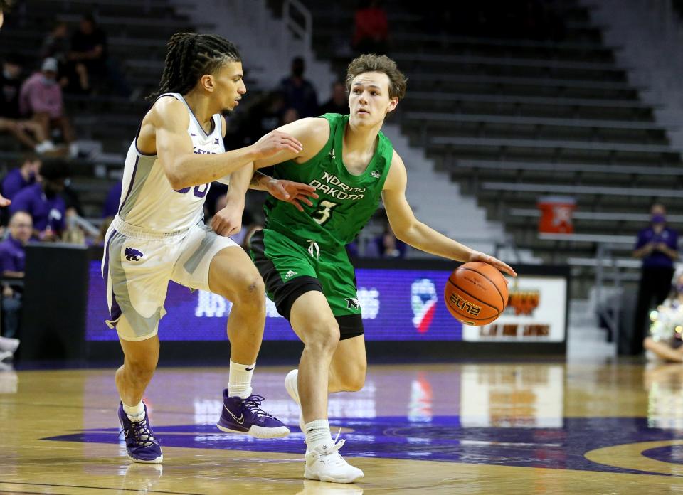 Nov 28, 2021; Manhattan, Kansas, USA; North Dakota Fighting Hawks guard Reid Grant (3) is guarded by Kansas State Wildcats guard Mike McGuirl (00) during the first half at Bramlage Coliseum. Mandatory Credit: Scott Sewell-USA TODAY Sports