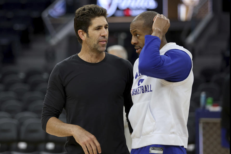 Golden State Warriors general manager Bob Myers, left, speaks with forward Andre Iguodala, right, during NBA basketball practice in San Francisco, Wednesday, June 1, 2022. The Warriors are scheduled to host the Boston Celtics in Game 1 of the NBA Finals on Thursday. (AP Photo/Jed Jacobsohn)