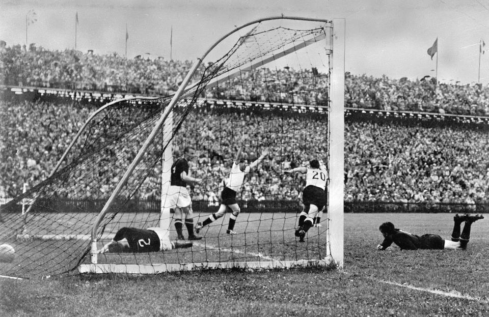 FILE - West Germany's Helmut Rahn, center with arms raised, celebrates after equalizing in the World Cup final soccer match against Hungary, at Wankdorf Stadium, in Bern, Switzerland on July 4, 1954. (AP Photo/File)