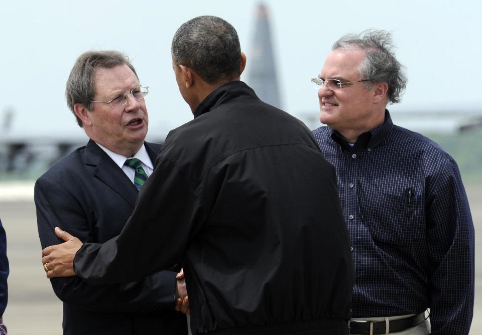 President Barack Obama, center, talks with Mark Stodola, Mayor of Little Rock, left, as Sen. Mark Pryor, D-Ark., right, watches after Obama walked off of Air Force One at Little Rock Air Force Base, Ark., Wednesday, May 7, 2014. Obama is visiting with first responders and families affected by the recent tornados. (AP Photo/Susan Walsh)