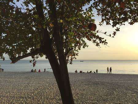 Tourists play at a beach front at the Preah Sihanoukville province, Cambodia November 26, 2017. REUTERS/Matthew Tostevin